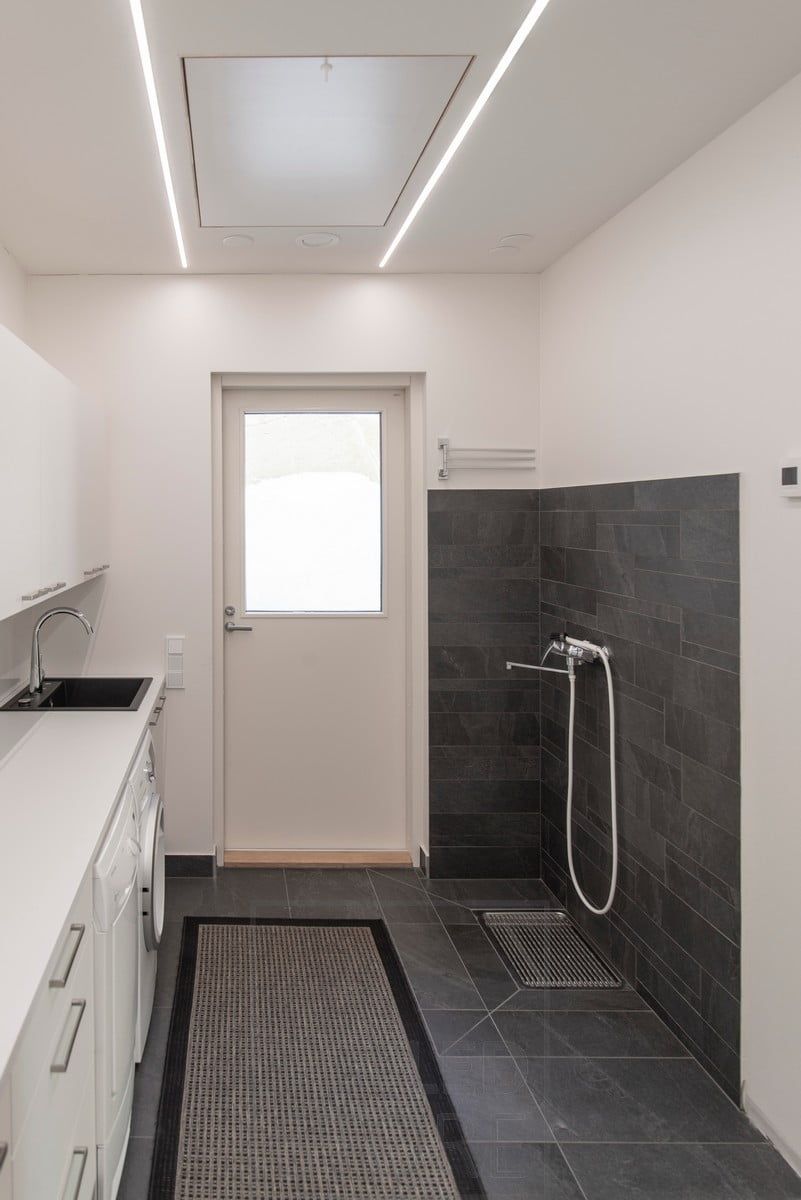 Minimalist ceiling lighting in a utility room with two narrow flush-mounted profiles